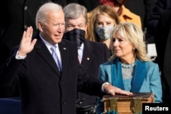 FILE - Joe Biden is sworn in as the 46th president of the United States by Chief Justice John Roberts as Jill Biden holds the Bible during the 59th Presidential Inauguration at the U.S. Capitol in Washington, U.S., January 20, 2021. (Andrew Harnik/Pool/REUTERS)