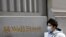 A person wearing a face mask walks along Wall Street after further cases of coronavirus were confirmed in New York City, New York, U.S., March 6, 2020. REUTERS/Andrew Kelly