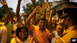 Supporters of Sri Lanka's ousted PM Ranil Wickremesinghe shout slogans as they celebrate after the Supreme Court suspended dissolution of parliament by President Sirisena, outside the court complex in Colombo, Sri Lanka, Nov. 13, 2018.