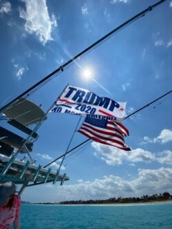 Carlos Gavidia flies a 'Trump' flag on his boat, to credit President Donald Trump for encouraging medicines that Gavidia says cured him of the coronavirus.