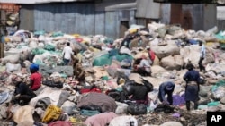 FILE—People scavenge recyclable materials for a living, at Dandora, the largest garbage dump in Nairobi, Kenya, April 22, 2024.