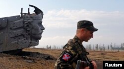 Un separatista prorruso vigila cerca de un monumento cerca de la ciudad de Donetsk.