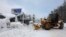 FILE - A plow clears snow after a heavy winter storm in Tahoe City, California, Jan. 11, 2017. 