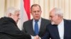 Russian Foreign Minister Sergei Lavrov, center, stands in the middle as Syrian Foreign Minister Walid Muallem, left, and Iranian Foreign Minister Mohammad Javad Zarif shake hands after a shared press conference following their talks focused on Syria in Moscow, Russia, April 14, 2017.