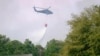 A helicopter drops water to help contain a fire in the Carolina Forest area west of the coastal resort city of Myrtle Beach, South Carolina, March 2, 2025, where residents were ordered to evacuate several neighborhoods. 