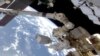 NASA Astronauts Conduct Space Walk Outside Space Station