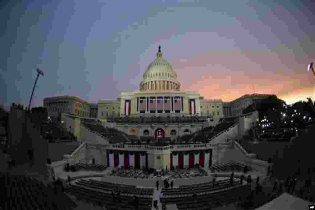 The sun rises behind the Capitol Dome early in the morning before the ceremonial swearing-in of President Barack Obama at the U.S. Capitol during the 57th Presidential Inauguration in Washington, Monday, Jan. 21, 2013. (AP Photo/Pablo Martinez Monsivais)