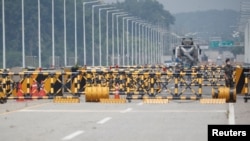 FILE - A soldier stands guard at a checkpoint on the Grand Unification Bridge which leads to the inter-Korean Kaesong Industrial Complex in North Korea, just south of the demilitarized zone separating the two Koreas, in Paju, South Korea, June 17, 2020. 