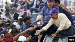 Dominican Republic President and Dominican Liberation Party (PLD) presidential candidate Danilo Medina (R) greets his supporters during a rally in Santo Domingo, Dominican Republic, May 12, 2016.