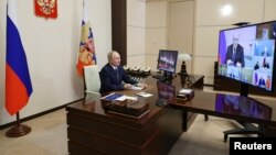 FILE: Russian President Vladimir Putin chairs a meeting via a video link from the Novo-Ogaryovo state residence outside Moscow, Russia January 17, 2023. 