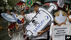 Protesters display slogans during a rally against the controversial immunization of more than 700,000 Filipino children with the anti-dengue vaccine Dengvaxia in Manila, Philippines, Dec. 18, 2017. The controversial vaccine, manufactured by Sanofi Pasteur was recently put on hold by the Philippines after new study findings showed it posed risks of severe cases in people without previous infection. The controversy has prompted the Philippine Senate to conduct an investigation.