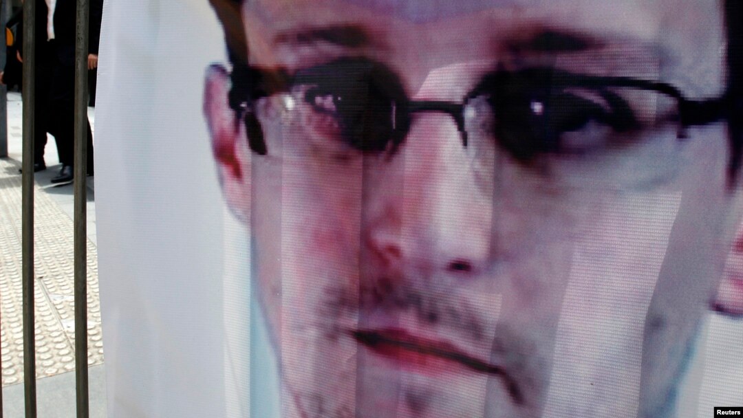 A banner supporting Edward Snowden, a former contractor at the National Security Agency (NSA), is displayed at Hong Kong's financial Central district on June 21, 2013