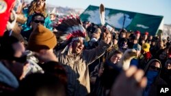 A crowd gathers in celebration at the Oceti Sakowin camp after it was announced that the U.S. Army Corps of Engineers won't grant easement for the Dakota Access oil pipeline in Cannon Ball, N.D., Dec. 4, 2016.