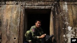 A Cambodian soldier polishes his boots at the 11th-century Preah Vihear temple on the border between Thailand and Cambodia, February 8, 2011.