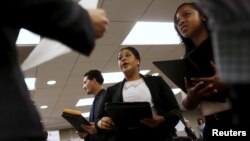 Job seekers listen to prospective employers during a job hiring event for marketing, sales and retail positions in San Francisco, California, June 4, 2015.