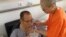 FILE - Chinese dissident and Nobel Prize laureate Liu Xiaobo, left, is attended to by his wife Liu Xia in a hospital in China. 