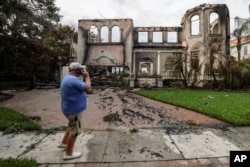 Joe Daum looks at the remains of a friend's home that burned during Hurricane Helene on Davis Island on Sept. 28, 2024, in Tampa, Florida.