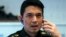 FILE - Winthai Suvaree, a spokesman for the Thai military government's NCPO, speaks on his mobile phone during an interview with Reuters at the Royal Army headquarters in Bangkok, Sept. 11, 2014.