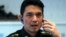 FILE - Winthai Suvaree, a spokesman for the Thai military government's NCPO, speaks on his mobile phone during an interview with Reuters at the Royal Army headquarters in Bangkok, Sept. 11, 2014.