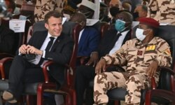 French President Emmanuel Macron and the son of the late Chadian president Idriss Deby, general Mahamat Idriss Deby, attend the state funeral for the late Chadian president Idriss Deby in N'Djamena, Apr. 23, 2021.