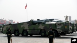 FILE - Vehicles carrying DF-17 ballistic missiles roll during a parade to commemorate the 70th anniversary of the founding of Communist China in Beijing, Oct. 1, 2019.