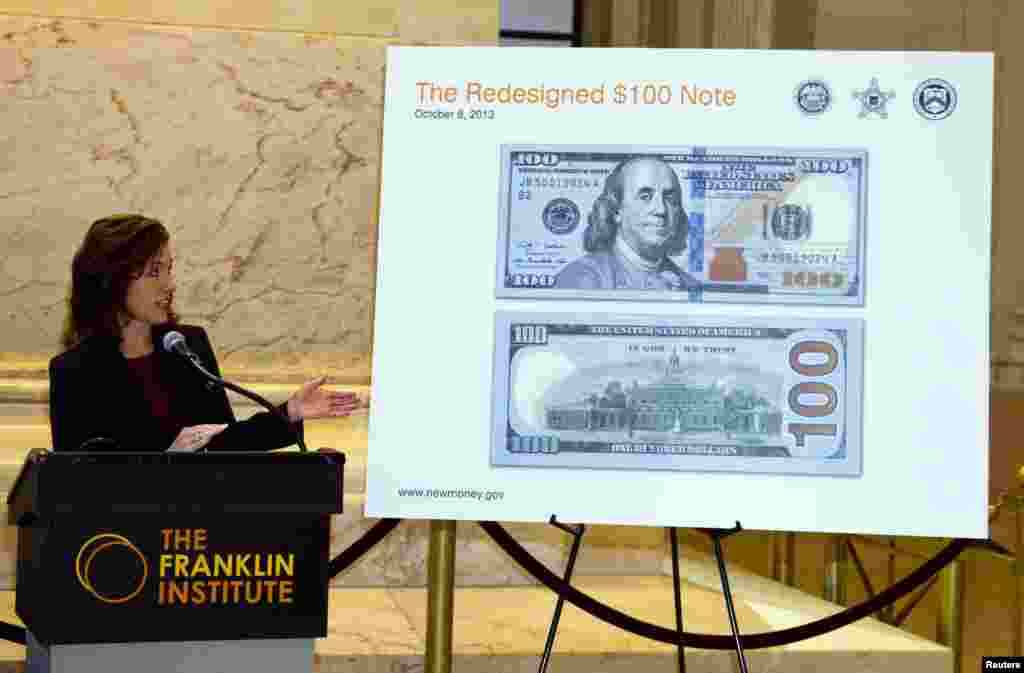 The new U.S. $100 bill is introduced by Michelle Scipione, vice president of the Philadelphia Federal Reserve Bank Cash Services Department, during an event at the Benjamin Franklin National Memorial in Philadelphia, Pennsylvania.