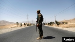 An Afghan National Army (ANA) soldier keeps watch at a checkpoint on the Ghazni highway, in Maidan Shar, the capital of Wardak province, Afghanistan, Aug. 12, 2018.