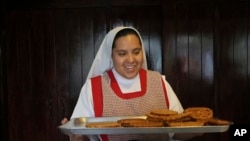 FILE - Nun Maria de Jesus Frayle, 24, holds a tray with fried Christmas figures at the Mothers Perpetual Adorers of the Blessed Sacrament convent in Mexico City, December 7, 2023.