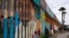 A man looks through the first wall at Friendship Park, near where the border separating Tijuana, Mexico, and San Diego meets the Pacific Ocean Tuesday, Jan. 19, 2021, in Tijuana, Mexico. In the days before Joe Biden became president, construction…