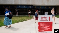 FILE - Students exit the KSU Ice Arena after getting their Johnson & Johnson COVID-19 vaccination at Kent State University in Kent, Ohio.