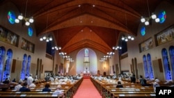 FILE - People attend mass held in memory of bomb victims at Urakami Church to mark the 75th anniversary of the atomic bombing of Nagasaki, in the city on Aug. 9, 2020.