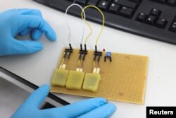 Rechargeable edible batteries made from food are displayed at Istituto Italiano di Tecnologia in Milan