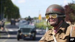 World War II history enthusiasts parade in WWII vehicles in Ouistreham, Normandy, June 5, 2021, on the eve of 77th anniversary of the assault that helped end World War II. 