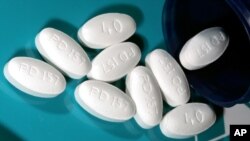 FILE - One kind of statin used for lowering blood cholesterol, 40 milligram tablets of Lipitor, are shown in Glen Rock, N.J., Nov. 15, 2005. 