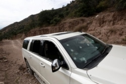 A bullet-riddled vehicle that members of the LeBaron family were traveling in sits parked on a dirt road near Bavispe, Mexico, Nov 6, 2019.