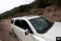 A bullet-riddled vehicle that members of the LeBaron family were traveling in sits parked on a dirt road near Bavispe, Mexico, Nov 6, 2019.