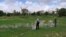 FILE - Researcher and field assistant taking measurements on a puddle in Zindarou, southwestern Niger. Niger is among the world's poorest countries and consistently ranked bottom of the U.N. Human Development Index.
