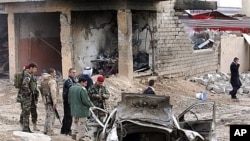 Iraqi security forces inspect scene of the attack near Mosul, Jan. 16, 2012.