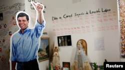 A cardboard cutout of jailed opposition leader Leopoldo Lopez is seen next to a religious altar, at the office of the party Popular Will (Voluntad Popular) in Caracas, Venezuela, Jan. 18, 2017. 