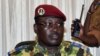 Burkina Faso's Lieutenant-Colonel Yacouba Isaac Zida (L) listens a statement is read at the end of a meeting with the country's military commanders, Nov. 1, 2014, at the military headquarters in Ouagadougou.