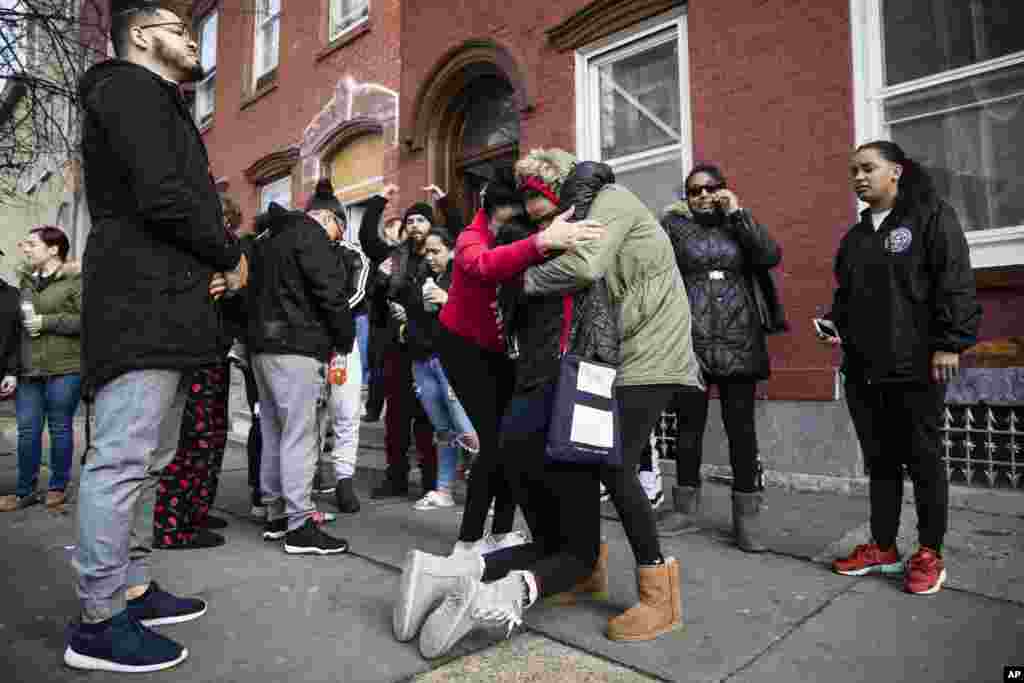 Mourners gather where authorities say at least four people have been shot to death the day before, in Reading, Pennsylvania.
