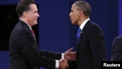 U.S. President Barack Obama (R) and Republican Presidential nominee Mitt Romney shake hands at the conclusion of the final presidential debate at Lynn University in Boca Raton, Florida October 22, 2012. 