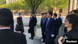 Members of Chinese Commerce Vice Minister Wang Shouwen’s delegation wait to be admitted into the U.S. Treasury Department for trade talks with members of the Trump administration in Washington, D.C., Aug. 23. 2018.