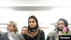 FILE - Mourners attend a vigil in memory of Iranian student Amir Moradi, who was killed in the crash of a Ukrainian passenger plane near Tehran, at Queens University in Kingston, Ontario, Canada, Jan. 10, 2020.