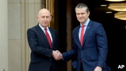 Defense Secretary Pete Hegseth, right, welcomes Britain's Defense Secretary John Healey to the Pentagon, March 6, 2025, in Washington.