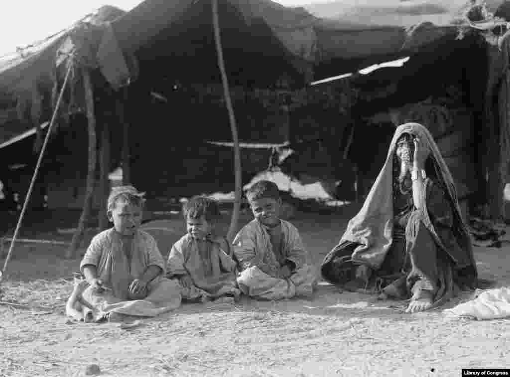 Bedouin woman and children in tent near Beersheba, ca. 1920-1930. At the time--and up until the mid 20th Century, the Bedouin were known as the "Arabs of Beersheba (‘arab as-saba’). The Bedouins called themselves 'Arab'