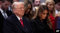 President Donald Trump, left, and first lady Melania Trump attend the national prayer service at the Washington National Cathedral, Jan. 21, 2025, in Washington.