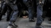 Police officers remove anti-far-right protesters blocking the route of a far-right demonstration, a day before the German election, in Berlin, Germany, on Feb. 22, 2025.