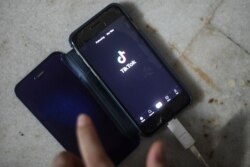 A person uses the video-sharing app TikTok on a smartphone.