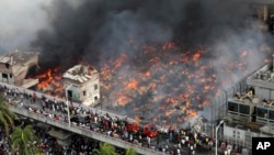 A fire rages at a popular market for cheaper clothes in Bangladesh's capital Dhaka, Bangladesh, April, 4, 2023. 